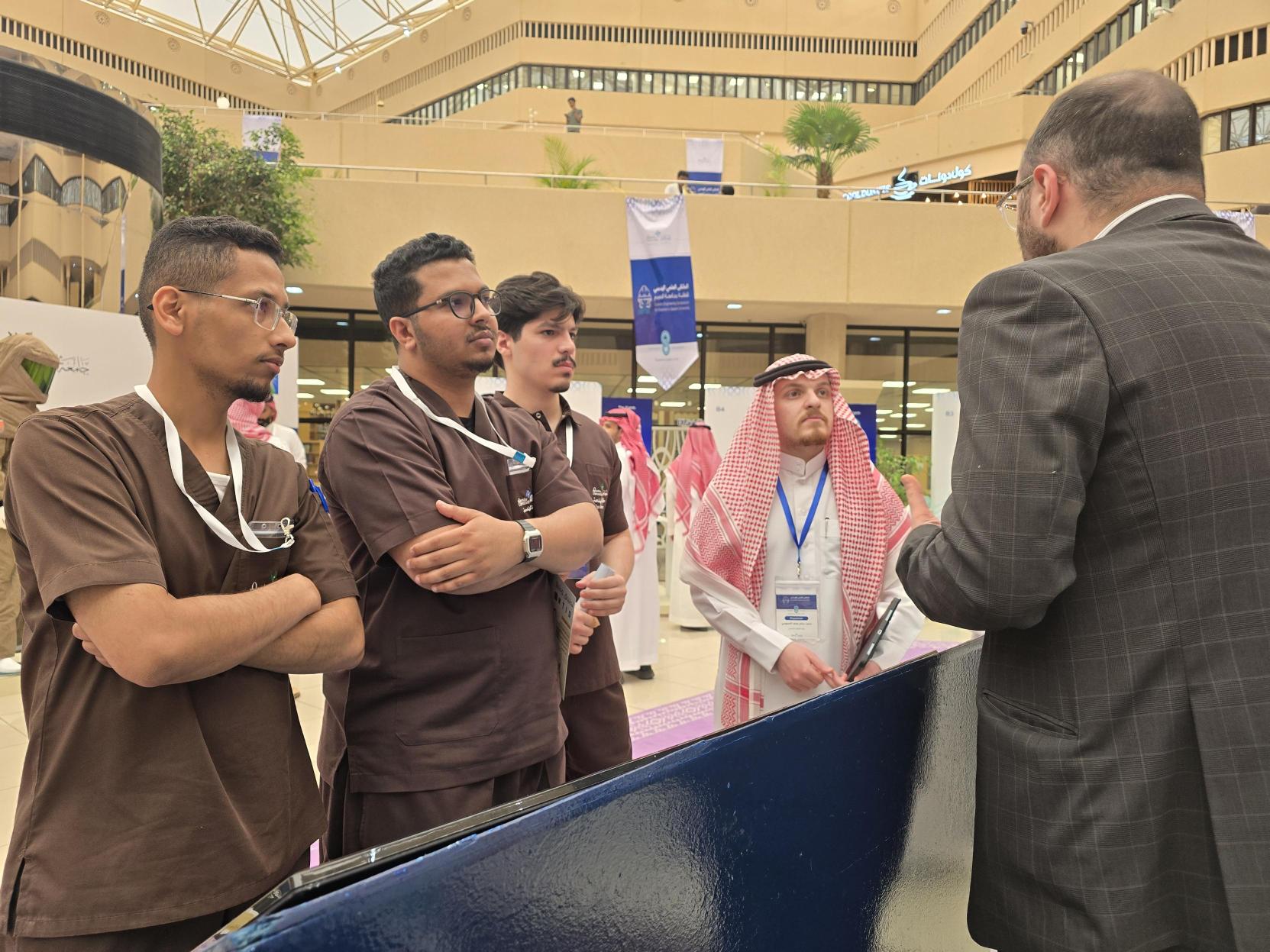 DG Jones and Partners representative speaking with engineering students at the Qassim University Scientific Engineering Symposium