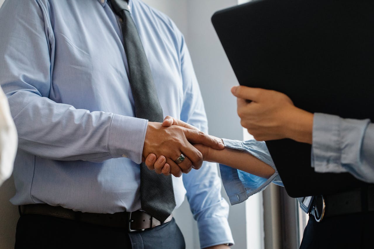 a construction manager shaking hands with a client