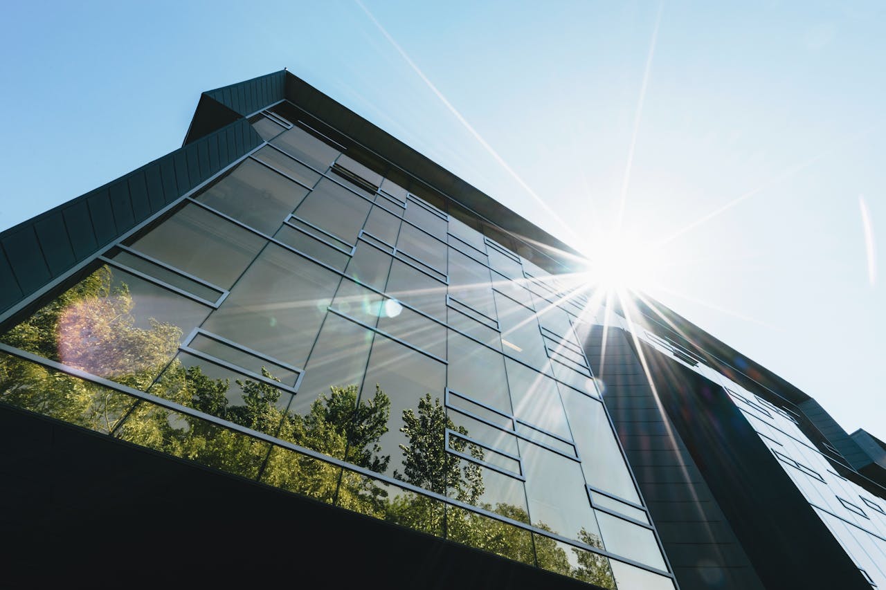 sunlight reflection off of a modern green building